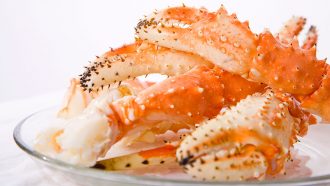 a pile of cooked crab claws on a plate