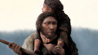 a man wearing furs carries a young girl on his shoulders