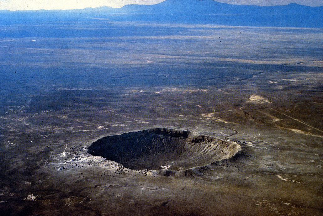 a large crater in a desert landscape